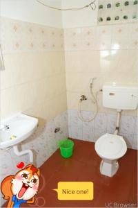a small bathroom with a sink and a toilet at Breezy Land Residency (Nidhi Sri & k.k resort) in Yercaud