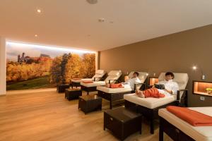 two people sitting in chairs in a room at Hotel Goldene Traube in Coburg