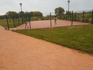 a group of people playing tennis on a tennis court at FamilyConfort Saidia in Saïdia
