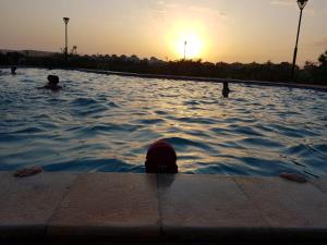a group of people swimming in a swimming pool at FamilyConfort Saidia in Saïdia