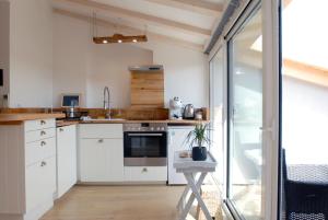 a kitchen with white cabinets and a sink at Casa Colloredo Free Parking in Rovinj