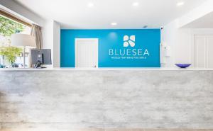 a blue and white sign on a white wall at BLUESEA Arenal Tower Adults Only in El Arenal
