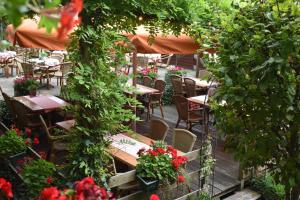 an outdoor patio with tables and chairs and flowers at Hotel De Vrouwe van Stavoren in Stavoren