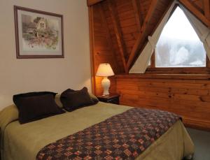 a bedroom with a bed and a large window at Village Catedral Hotel & Spa in San Carlos de Bariloche