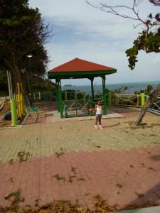a little girl standing in front of a playground at Casa turistica Miss G in Providencia