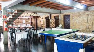 a dining room with a table and a pool table at Pousada Albatroz in Ubatuba
