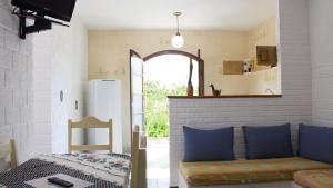 a living room with a couch and a window at Pousada Albatroz in Ubatuba