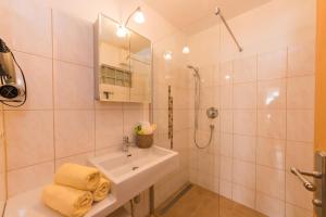 a white bathroom with a sink and a shower at Oberdeutinghof in Saalfelden am Steinernen Meer +67 photos