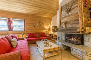 a living room with a fireplace in a log cabin at Le Paradis 18 - Chamonix All Year in Chamonix