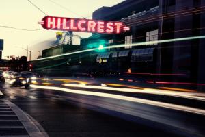 a busy city street with cars driving past a building at Hillcrest House Bed & Breakfast in San Diego