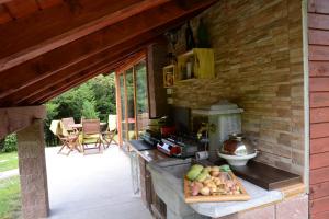 an outdoor kitchen with a counter with fruit on it at Studio ALPIKA in Luče