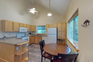 a kitchen with a wooden table and a dining room at The Great Escape in Gunnison in Gunnison