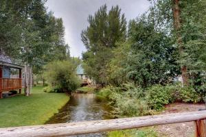a river in a yard with a wooden fence at The Great Escape in Gunnison in Gunnison