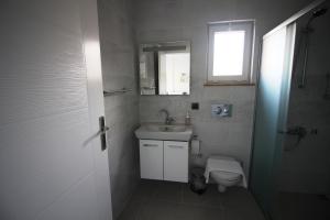 a bathroom with a sink and a toilet and a window at Dalyan Villa MoonLight in Dalyan +21 photos