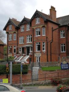 a brick building with a sign in front of it at The Grove in Whitby