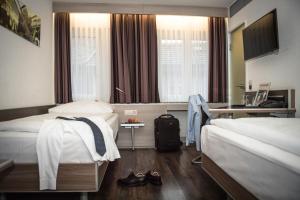 Posteľ alebo postele v izbe v ubytovaní Hotel Alexander Zurich Old Town