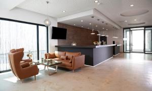 a living room with a couch and a table at Hotel New In in Ingolstadt