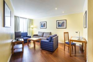a living room with a couch and a table at Holiday Inn Lisbon by IHG in Lisbon