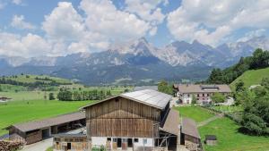 an aerial view of a farm with mountains in the background at Oberdeutinghof in Saalfelden am Steinernen Meer