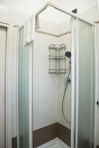 a shower with a glass door in a bathroom at Venetian Mood: Secret Garden in Venice
