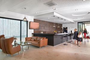 a woman and a little girl standing in a living room at Hotel New In in Ingolstadt