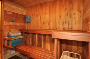 a wooden sauna with a wooden bench in it at RiverTree Inn & Suites in Clarkston