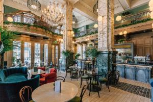 a restaurant with tables and chairs and a bar at The Scotsman Hotel in Edinburgh