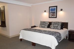 Postel nebo postele na pokoji v ubytování Hotel Novalux