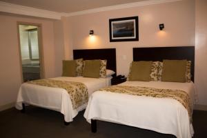 Postel nebo postele na pokoji v ubytování Hotel Novalux