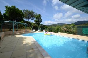 a swimming pool with a pool toy in the middle at Les Arches - Pardigon in La Croix-Valmer