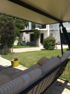 a hammock in a yard with a house in the background at Place in the Sun in Gouvia