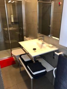 a bathroom with a sink and a shower at La Casa de Antón in Tineo