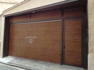 a garage door with the word garage on it at Hôtel Alchimy in Albi