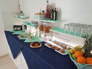 a counter topped with lots of different types of food at Hotel Daisy in San Giovanni Lupatoto