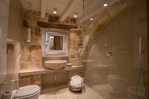 a bathroom with a sink and a toilet at Casa Regina Paola in Monopoli