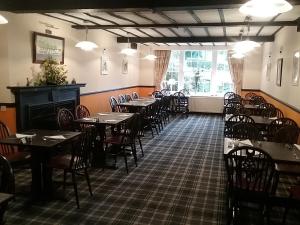 an empty dining room with tables and chairs at Cross Keys Hotel in Canonbie