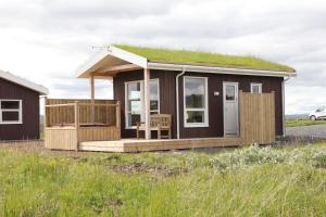 a tiny house with a grass roof at Blue View Cabin 5B With private hot tub in Reykholt