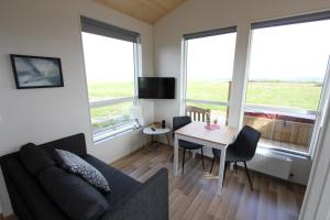 a living room with a couch and a table at Blue View Cabin 5B With private hot tub in Reykholt