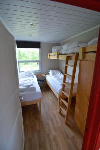 ein kleines Zimmer mit 2 Etagenbetten und einem Fenster in der Unterkunft Bragdavellir Holiday Home in Djúpivogur