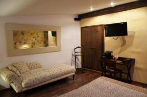 a living room with a couch and a table and a television at Hotel Galena Mas Comangau in Begur