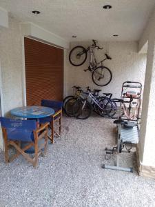 una mesa con sillas y una bicicleta en la pared en Michel Studios, en Kalavrita