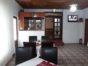 a meeting room with a table and chairs and a door at Montana Touring in Nehoiu