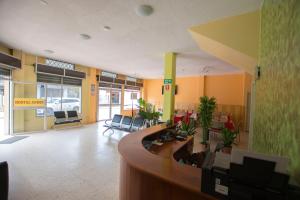 a lobby of a hospital with a reception desk and chairs at Hostal Andry in Puerto Baquerizo Moreno