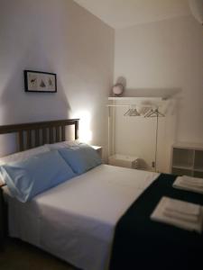 a bedroom with a large white bed and a lamp at B&B La Terrazza Near The Beach in Bari +38 photos