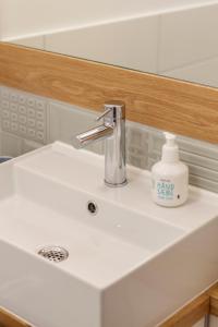 a sink with a faucet and a bottle of soap at Gästezimmer St. Dionys in Sankt Dionys