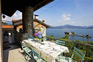 een tafel op een balkon met uitzicht op het water bij Casa Bougainville in Cannobio