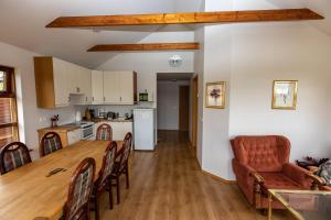 a kitchen and living room with a table and chairs at Lysuholl in Snæfellsbær