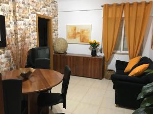 uma sala de estar com mesa e cadeiras em My apartment in Sacavém em Sacavém