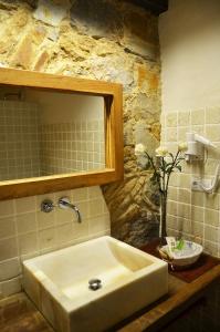 a bathroom with a sink and a mirror at Hotel Galena Mas Comangau in Begur