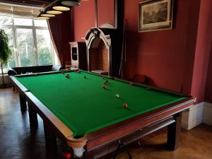 a pool table with balls on it in a room at Château Lambert Hotel-Resto-Parking-Shuttle airport, 3 saloons, snooker, large terrasse in Charleroi